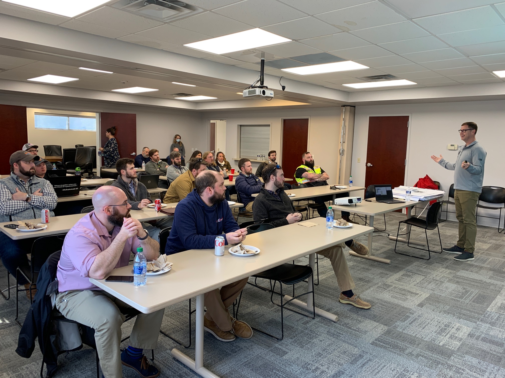 People attending a seminar or workshop in a classroom setting.